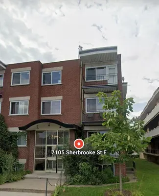 a brick building with a sign in front of it at Chez Walid in Montréal