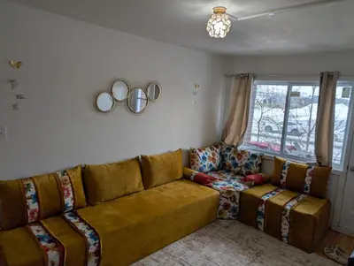 a living room with a couch and a window at Chez Walid in Montréal