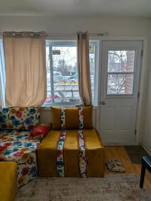 a living room with a couch and a window at Chez Walid in Montréal