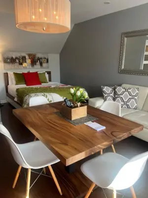 a dining room with a table and a bed at L'intime loft Studio à Orford in Magog-Orford