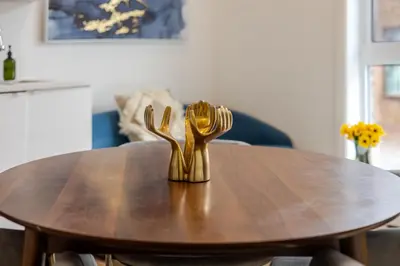 a table with two gold forks on top of it at Peaceful 1BR Getaway Near MTL Village in Montréal