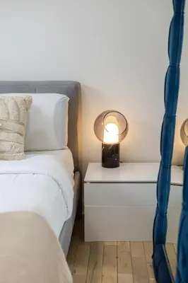a bedroom with a bed and a lamp on a nightstand at Peaceful 1BR Getaway Near MTL Village in Montréal