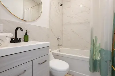 a bathroom with a sink toilet and a mirror at Peaceful 1BR Getaway Near MTL Village in Montréal