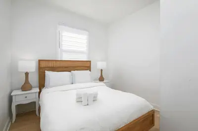 a bedroom with a white bed with white pillows at Contemporary 2BR Retreat in MTL Village in Montréal