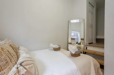 a white bed with baskets on it in a room at Delightful 2BR in Village Downtown in Montréal