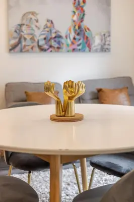 a white table with two gold sculptures on it at Delightful 2BR in Village Downtown in Montréal