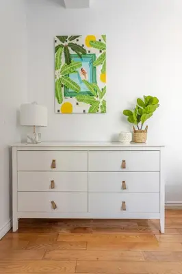 a white dresser with a lamp and a plant at Elegant 4 Bedroom residence in downtown MTL in Montréal
