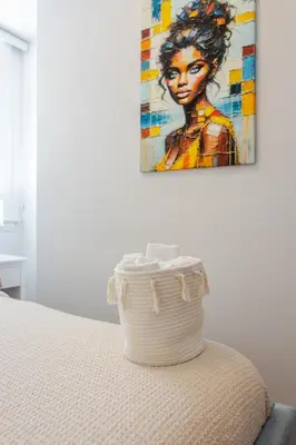 a basket sitting on top of a bed with a painting at Elegant 4 Bedroom residence in downtown MTL in Montréal