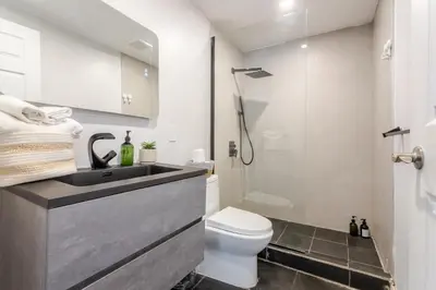 a bathroom with a sink and a toilet and a shower at Elegant 4 Bedroom residence in downtown MTL in Montréal