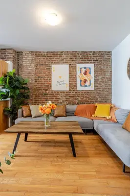 a living room with a couch and a coffee table at Prime Location Charming 4BR in Downtown MTL in Montréal