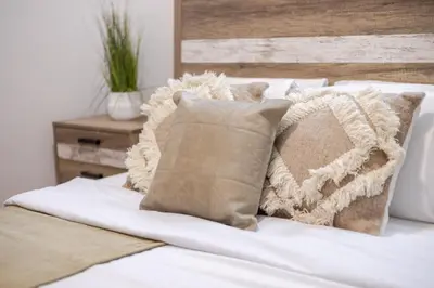 a pile of pillows sitting on top of a bed at Prime Location Charming 4BR in Downtown MTL in Montréal