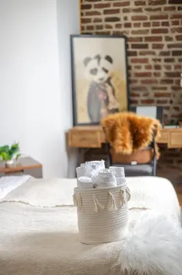 a bedroom with a bed with a chair and a panda bear picture at Prime Location Charming 4BR in Downtown MTL in Montréal