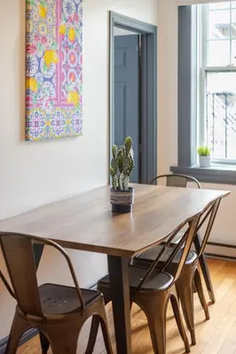 a dining room table with two chairs and a cactus at Prime Location Charming 4BR in Downtown MTL in Montréal