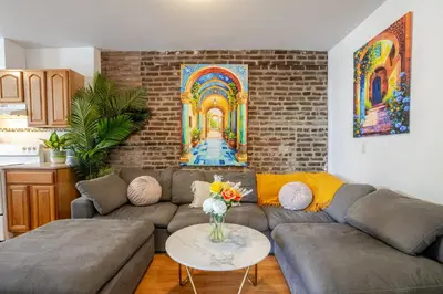 a living room with a couch and a table at Prime Location Gorgeous 4BR Downtown MTL in Montréal