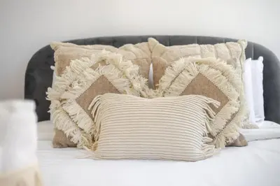 a group of pillows sitting on a bed at Prime Location Gorgeous 4BR Downtown MTL in Montréal