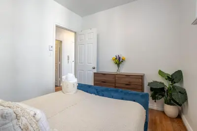 a bedroom with a blue couch and a dresser at Prime Location Gorgeous 4BR Downtown MTL in Montréal