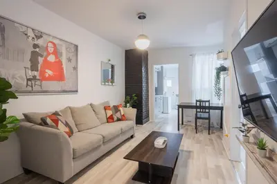 a living room with a couch and a table at Excellent 4 Bedroom in Griffintown Downtown MTL in Montréal