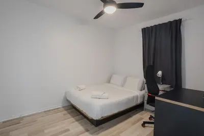 a bedroom with a bed and a ceiling fan at Excellent 4 Bedroom in Griffintown Downtown MTL in Montréal