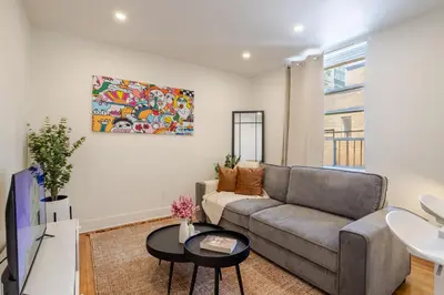 a living room with a couch and a table at Downtown Hideaway Peaceful and Trendy in Montréal