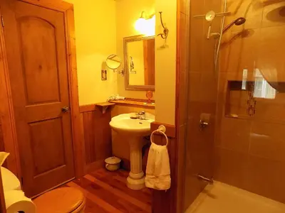 a bathroom with a sink and a toilet and a mirror at À L'Ancestrale B&B in Magog-Orford