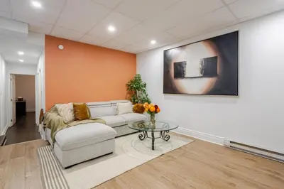 a living room with a couch and a table at Chic DT MTL Condo with Rooftop, BBQ in Montréal
