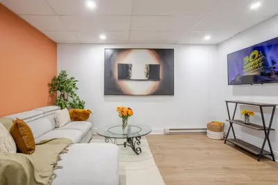 a living room with a couch and a table at Chic DT MTL Condo with Rooftop, BBQ in Montréal