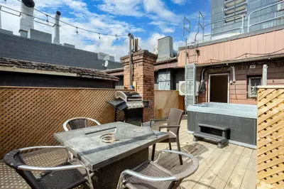 a patio with a table and chairs and a grill at Chic DT MTL Condo with Rooftop, BBQ in Montréal
