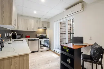 a kitchen with a laptop on a counter at Chic DT MTL Condo with Rooftop, BBQ in Montréal