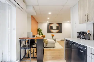 a kitchen and living room with a counter and a table at Chic DT MTL Condo with Rooftop, BBQ in Montréal