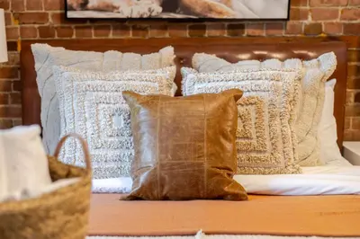 a group of pillows sitting on a bed at 3BDR Penthouse, Rooftop and BBQ in Crescent in Montréal