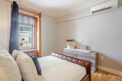 a bedroom with a bed and a window at 3BDR Penthouse, Rooftop and BBQ in Crescent in Montréal