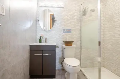 a bathroom with a toilet and a sink and a shower at 3BDR Penthouse, Rooftop and BBQ in Crescent in Montréal