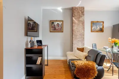 a living room with a couch and a table at 3BDR Penthouse, Rooftop and BBQ in Crescent in Montréal