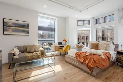 a living room with a bed and a couch at Urban Studio on Bishop Hot Spot Dtown MTL in Montréal