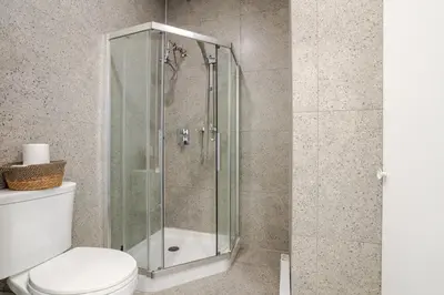a bathroom with a glass shower with a toilet at Urban Studio on Bishop Hot Spot Dtown MTL in Montréal