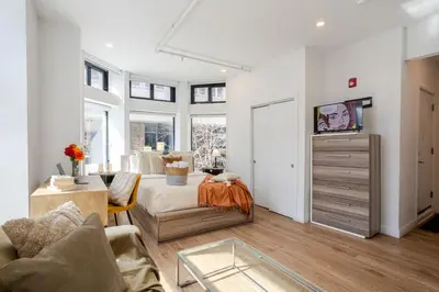 a living room with a bed and a table at Urban Studio on Bishop Hot Spot Dtown MTL in Montréal