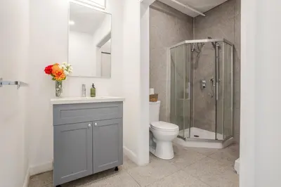 a bathroom with a toilet and a shower at Urban Studio on Bishop Hot Spot Dtown MTL in Montréal