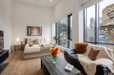a living room with a couch and a table at Lovely Loft with Views on Bishop - MTL in Montréal