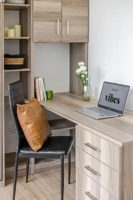 a desk with a laptop and a chair with a pillow at Lovely Loft with Views on Bishop - MTL in Montréal