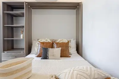 a bedroom with a bed with pillows on it at Modern 1BDR Apartment on Bishop - MTL in Montréal