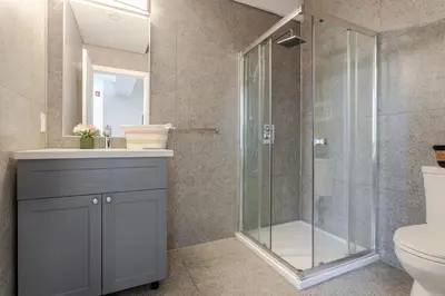 a bathroom with a shower and a toilet at Modern 1BDR Apartment on Bishop - MTL in Montréal