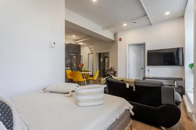 a room with a bed and a living room at Modern 1BDR Apartment on Bishop - MTL in Montréal