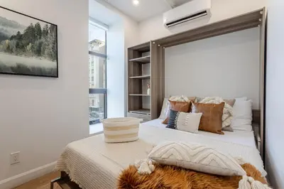 a bedroom with a bed with a large mirror at Modern 1BDR Apartment on Bishop - MTL in Montréal