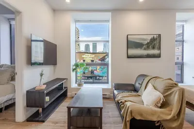 a living room with a couch and a table at Modern 1BDR Apartment on Bishop - MTL in Montréal