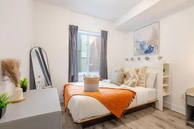 a bedroom with a bed and a window at Urban 1BDR Apartment on Bishop -MTL Live Spot in Montréal