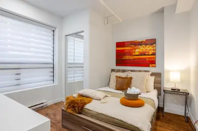 a bedroom with a bed and a window at Charming 1BDR Apartment on Bishop St- MTL in Montréal