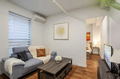 a living room with a couch and a table at Charming 1BDR Apartment on Bishop St- MTL in Montréal