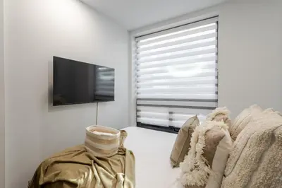a living room with a tv and a couch at 1BDR Mezzanine-Bishop-Vibe Central MTL in Montréal