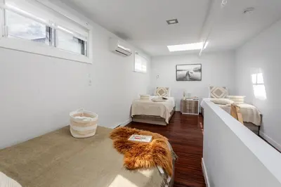 a living room with a couch and a rug at Spacious 1BDR Mezzanine on Bishop Central MTL in Montréal