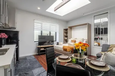 a living room with a couch and a table at Spacious 1BDR Mezzanine on Bishop Central MTL in Montréal